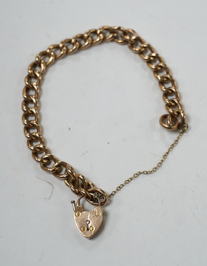 An early 20th century 9ct curb link bracelet, with heart shaped padlock clasp, 18cm, 13.6 grams. Condition - fair